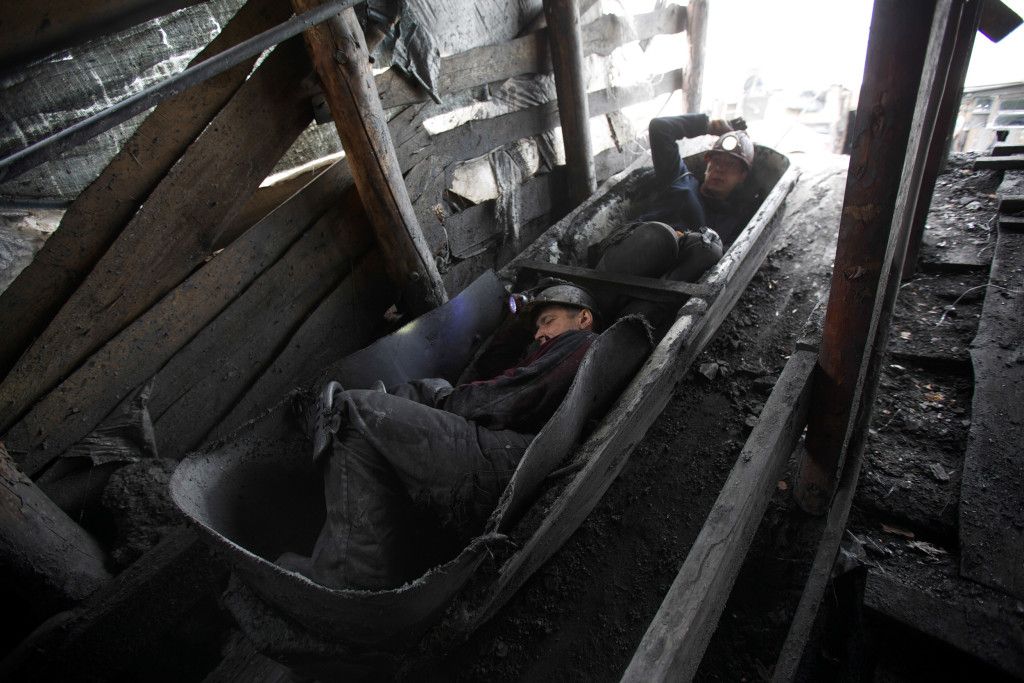Sergei Ivanov and Vovka hunched over in a canoe-like vessel that they call the “Boat” that will take them 390 feet below ground level inside this illegal mine in Shahtersk, eastern Ukraine on April 28, 2014. During their eight-hour shift they dig out and send up about 15 – 20 “boat” loads, between them they make about the equivalent of only three US dollars for every load they told me. Two month ago, they lost a friend and fellow miner at another illegal mine when the steel cable attached to the “Boat” snapped and the miner fell to his death deep underground. (Ghazi Balkiz/ NBC News)